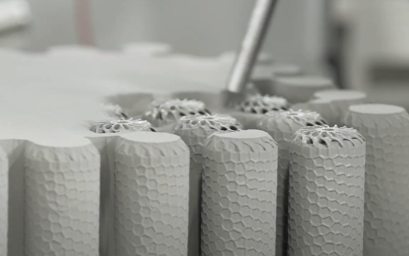 DMLS additive manufacturing build with lattice metal cylinders — AGF Defcom