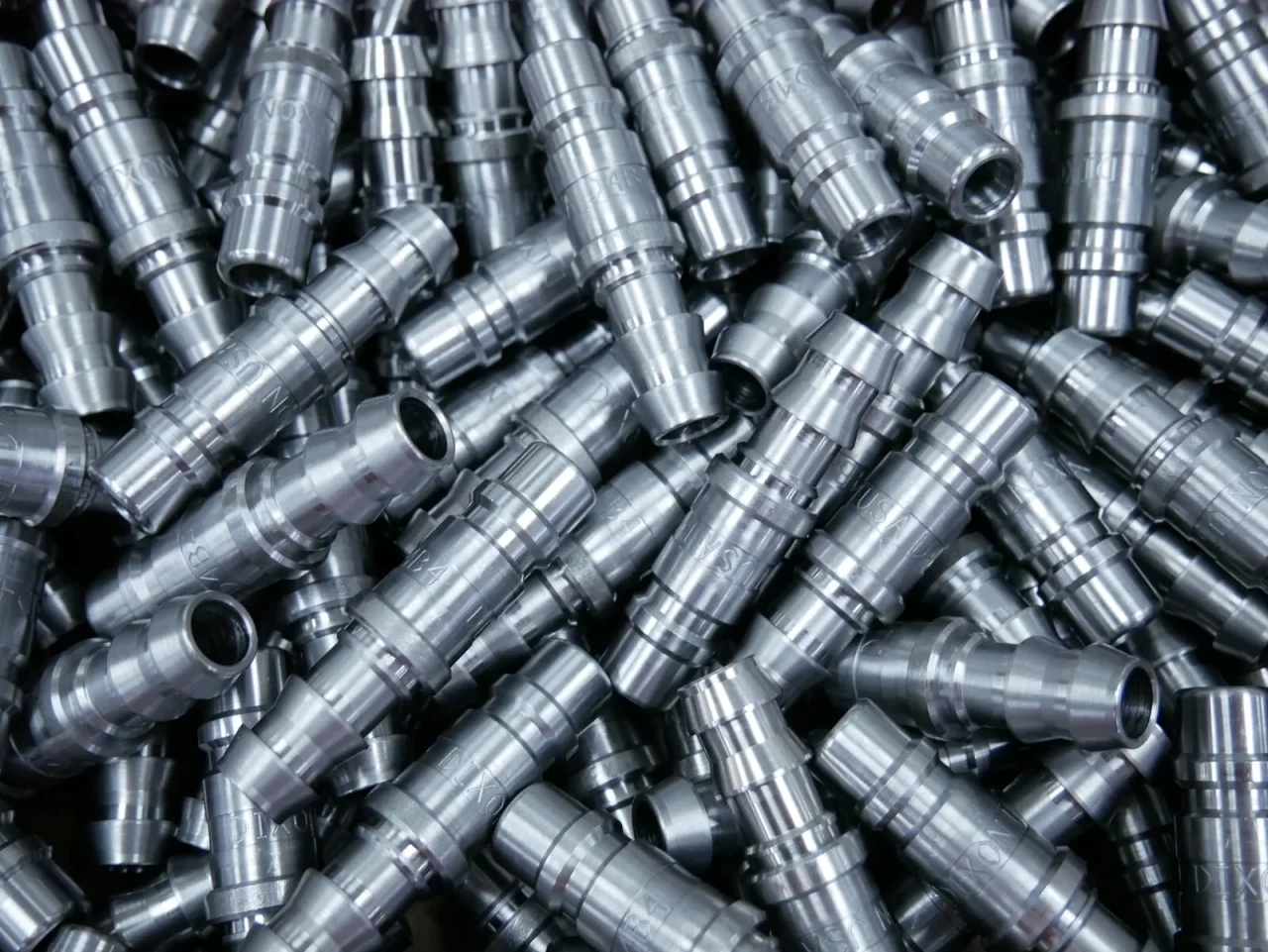 Pile of Swiss screw machined fittings – Chesapeake CNC