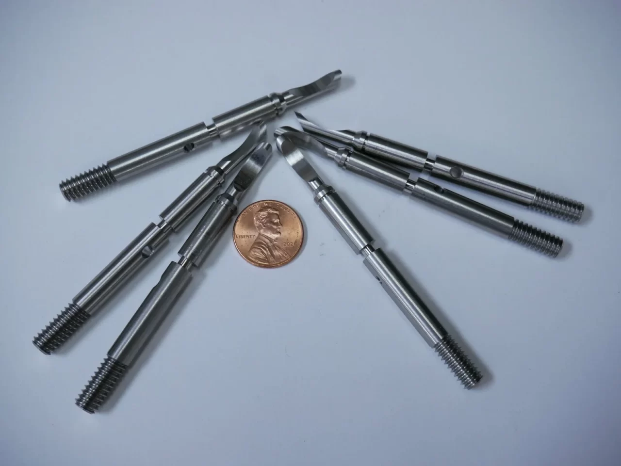 CNC machined fittings arranged with penny – Chesapeake CNC